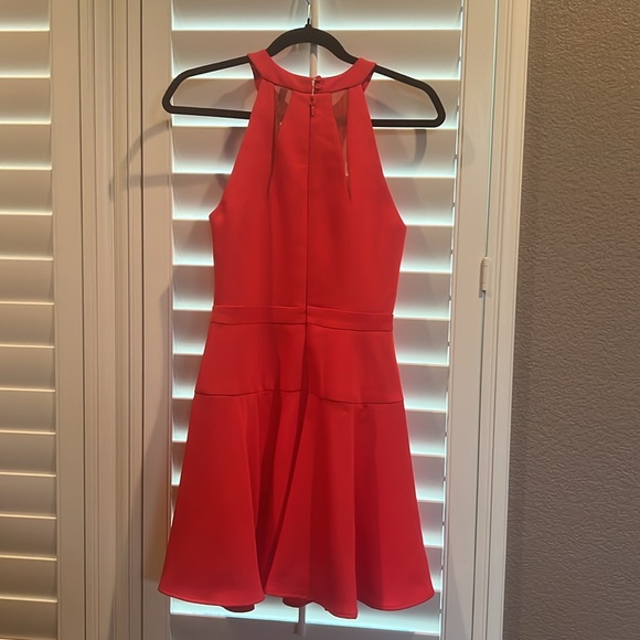 Orange/red short dress, accented darts flowing into a cinched waist band. - Picture 2 of 3
